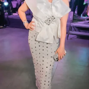 Classic , Timeless and Oh -so -Chic in white . @life.of.bobbyuppal looking Ravishing in our white tube top wrapped with satin pleating flaps and pencil fit calf length skirt with crystal embellishments .
